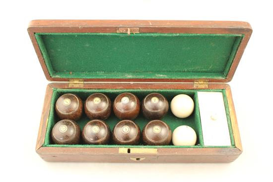 A mahogany cased set of indoor carpet bowls, 9.75in.
